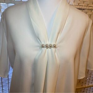 White blouse with decorative pearls on front center